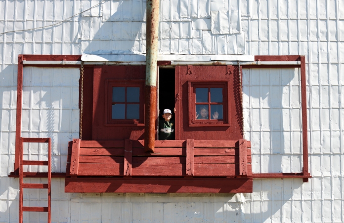 Eight-year-old Adam Smith and his 10-year-old Liam play in the Meeting Creek grain elevator during Alberta Open Farm Days. The brothers explored the elevator and the old train station as their mother helped out with the activities planned throughout the day in Meeting Creek, Alta. on Sunday August 23, 2015. Amielle Christopherson/Camrose Canadian/Postmedia Network